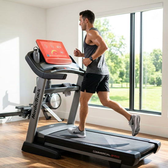 A man running on a NordicTrack Commercial 3.0 treadmill in a bright, modern gym with large windows and a wooden floor.